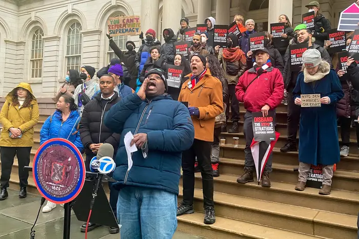 Jon McFarlane, a community organizer with VOCAL-New York, leads a chant at a rally outside City Hall Monday.